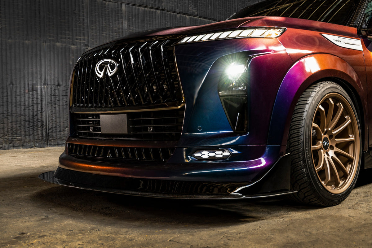INFINITI QX80 R-Spec, front three-quarter view in Midnight Purple with the wide-body kit and splitter