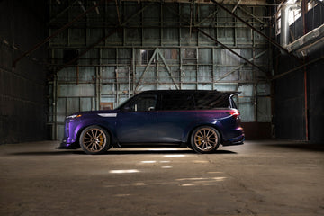 INFINITI QX80 R-Spec side profile showing the wide-body kit and side skirts