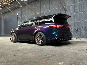 Finished Infiniti QX80 R-Spec in the studio, rear three-quarter view with the wing, side skirts and diffuser